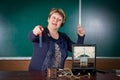 The teacher of physics explains concept of electromagnetic induction Royalty Free Stock Photo