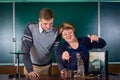 The teacher of physics explains to the pupil interaction of a magnetic field and electric field Royalty Free Stock Photo