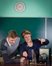 The teacher of physics explains to the pupil interaction of a magnetic field and electric field Royalty Free Stock Photo