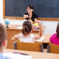 Teacher pointing at schoolgirl