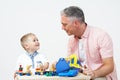 Teacher And Pre School Pupil Playing With Wooden Tools Royalty Free Stock Photo