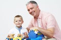Teacher And Pre School Pupil Playing With Wooden Tools Royalty Free Stock Photo