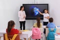 Teacher and pupil using interactive board in classroom during lesson Royalty Free Stock Photo