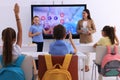 Teacher and pupil using interactive board in classroom during lesson Royalty Free Stock Photo