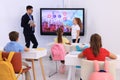 Teacher and pupil using interactive board in classroom during lesson Royalty Free Stock Photo