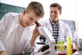 Teacher with pupil using microscope in class Royalty Free Stock Photo