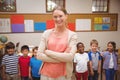 Teacher and pupils smiling at camera in classroom Royalty Free Stock Photo