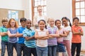 Teacher and pupils smiling at camera in classroom Royalty Free Stock Photo