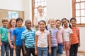 Teacher and pupils smiling at camera in classroom Royalty Free Stock Photo