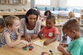 Teacher And Pupils Using Wooden Shapes In Montessori School Royalty Free Stock Photo