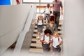 Teacher And Pupils Walking Down Stairs In Busy Elementary School Corridor Royalty Free Stock Photo