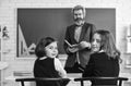 Teacher and pupils working at desk together at the elementary school. disclose and develop creativity. Teacher working