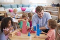 Teacher And Pupils Working At Tables In Montessori School Royalty Free Stock Photo
