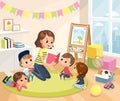 Teacher reading book to children in a kindergarden classroom. Royalty Free Stock Photo