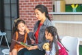 Teacher reading story book to kindergarten students hand on head Royalty Free Stock Photo