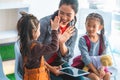 Teacher reading story book to kindergarten students hi five Royalty Free Stock Photo