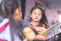 Teacher reading story book to kindergarten students Kid Royalty Free Stock Photo