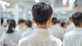 A teacher's back view with rows of students in uniforms facing a blackboard.. AI generated Royalty Free Stock Photo