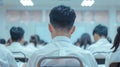 A teacher's back view with rows of students in uniforms facing a blackboard.. AI generated Royalty Free Stock Photo