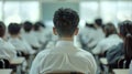 A teacher's back view with rows of students in uniforms facing a blackboard.. AI generated Royalty Free Stock Photo
