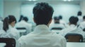 A teacher's back view with rows of students in uniforms facing a blackboard.. AI generated Royalty Free Stock Photo