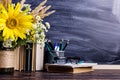 Teacher`s day holiday greeting icon. Education knowledge concept. Wooden chalk board frame and vase bouquet on table empty copy