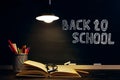 The teacher's desk or a worker, on which the writing materials lie, a books, in the evening under the lamp. Blank for text or Royalty Free Stock Photo