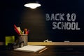 The teacher's desk or a worker, on which the writing materials lie, a books, in the evening under the lamp. Blank for text or Royalty Free Stock Photo