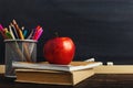 Teacher`s desk with writing materials, a book and an apple, a blank for text or a background for a school theme. Copy space Royalty Free Stock Photo