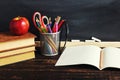 Teacher`s desk with writing materials, a book and an apple, a blank for text or a background for a school theme. Copy space Royalty Free Stock Photo