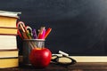 Teacher`s desk with writing materials, a book and an apple, a blank for text or a background for a school theme. Copy space Royalty Free Stock Photo