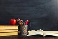 Teacher`s desk with writing materials, a book and an apple, a blank for text or a background for a school theme. Copy space Royalty Free Stock Photo