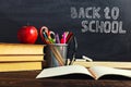 Teacher's desk with writing materials, a book and an apple, a blank for text or a background for a school theme. Copy space Royalty Free Stock Photo