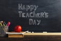 Teacher's desk with writing materials, a book and an apple, a blank for text or a background for a school theme. Copy space Royalty Free Stock Photo