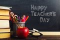 Teacher's desk with writing materials, a book and an apple, a blank for text or a background for a school theme. Copy space Royalty Free Stock Photo