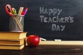 Teacher's desk with writing materials, a book and an apple, a blank for text or a background for a school theme. Copy space Royalty Free Stock Photo