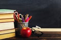 Teacher`s desk with writing materials, a book and an apple, a blank for text or a background for a school theme. Copy space Royalty Free Stock Photo