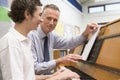 Teacher with schoolboy playing piano Royalty Free Stock Photo
