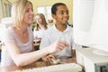 Teacher and schoolboy studying on a computer Royalty Free Stock Photo