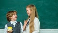 Teacher schoolgirl helping schoolboy with lesson. Education. Kids education. Girl and boy with happy face expression Royalty Free Stock Photo
