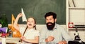 Teacher and schoolgirl. Man bearded pedagogue and pupil having fun. Developing caring learners who are actively growing Royalty Free Stock Photo