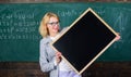 Teacher show school information. Remember this information. Teacher smart smiling woman hold blackboard blank