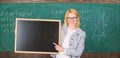 Teacher show school information. Teacher smart smiling woman hold blackboard blank advertisement copy space. Remember