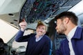 teacher showing apprentice overhead controls in aircraft cockpit Royalty Free Stock Photo