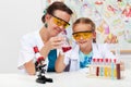 Teacher showing basic chemistry experiment to a little student Royalty Free Stock Photo
