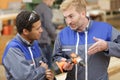 teacher showing drill to carpentry student