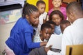 Teacher showing kids a book during elementary school lesson