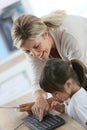 Teacher showing little girl how to use computer Royalty Free Stock Photo