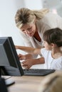 Teacher showing little girl how to use computer Royalty Free Stock Photo