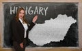 Teacher showing map of hungary on blackboard